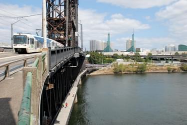 Looking east from the upper level of the Steel Bridge, in Portland, Oregon. The pedestrian walkway on the lower level, connecting to the Eastbank Esplanade, was installed in 2001; photo by Steve Morgan