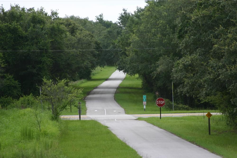 "Stop Ahead" sign warns trail users of road crossing on Withlacoochie State Trail, Florida