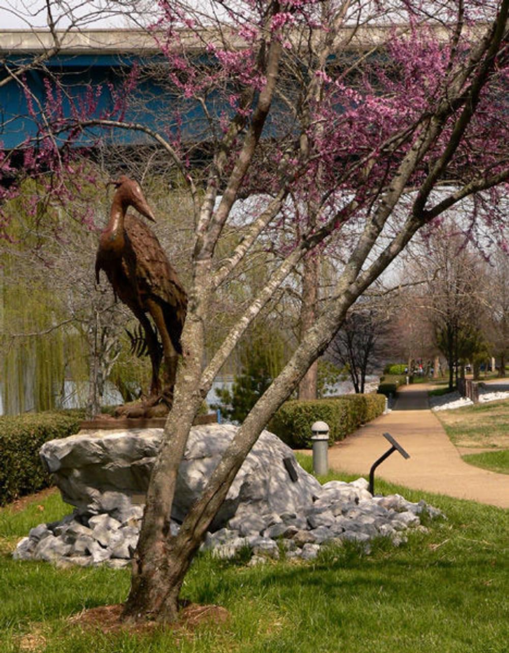 Heron sculpture at Fishing Park on the Tennessee Riverpark in Chattanooga, TN: "Great Blue Heron with Olive Branch" by artist Jack Denton, 2000. C. B. Robinson Bridge is in the background