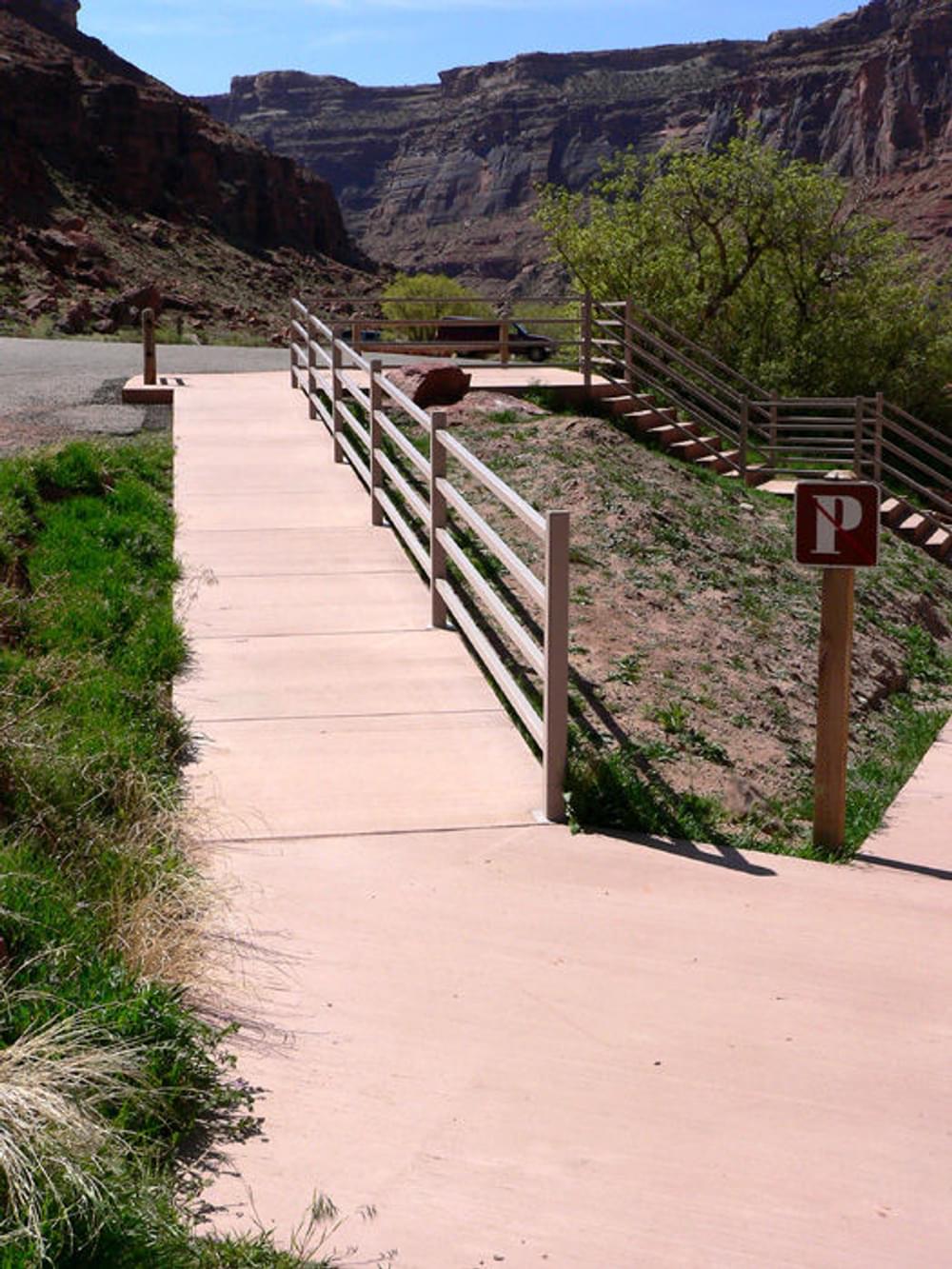 Concrete trail to restrooms with alternative stairs. Note handrail on one side of the trail.