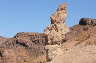 An unusual rock formation catches hikers' eye. Created by water erosion, this formation is called a "hoodoo"; photo by Sue McDonald