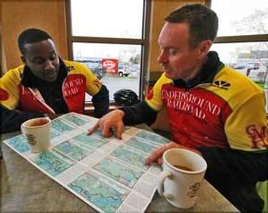 Cyclists reading an Underground Railroad Bicycle Route map