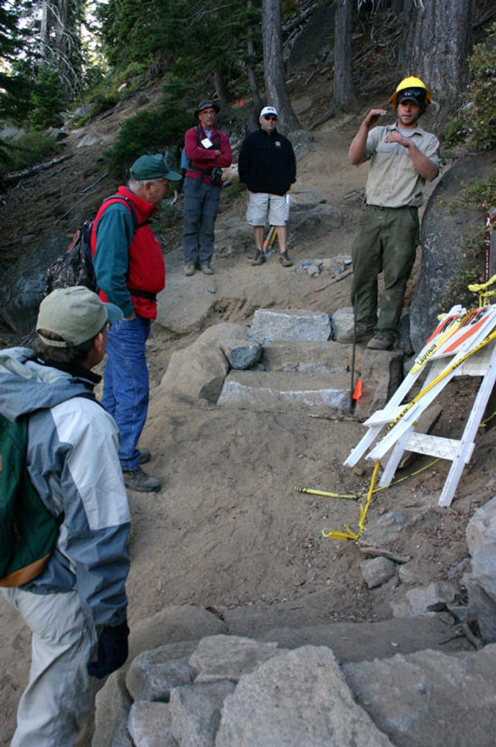 California State Parks trail builder discussing rock stair construction at D.L. Bliss State Park; Lake Tahoe