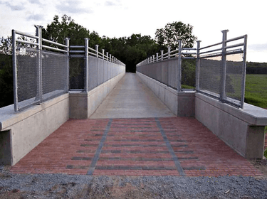 Cedar View Trail bridge. Completed pavers remind trail users of railroad history of this particular trail corridor; Artist Judy Bales