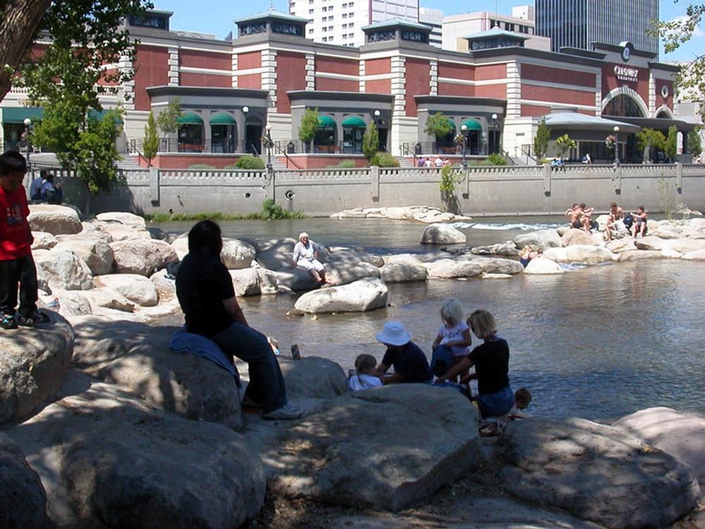 Rocks provide erosion control and access to the Truckee River in downtown Reno, Nevada. A trail runs above the flood wall on each side of the river.