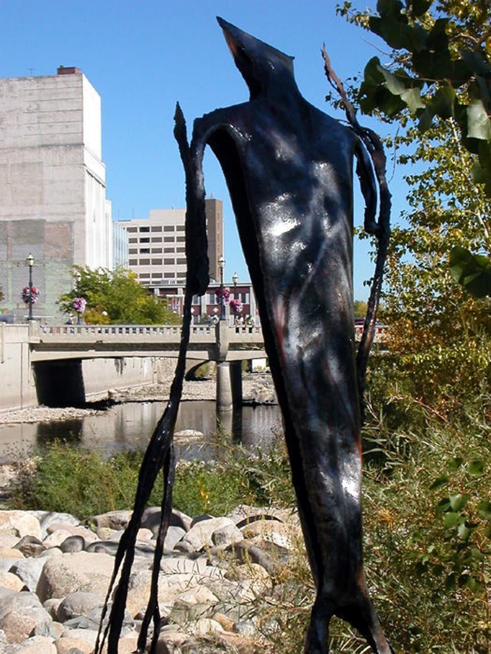One of the large metal sculptures in the flood plain of the Truckee River in downtown Reno, Nevada. A trail on each side of the river flood wall looks down on the sculptures.