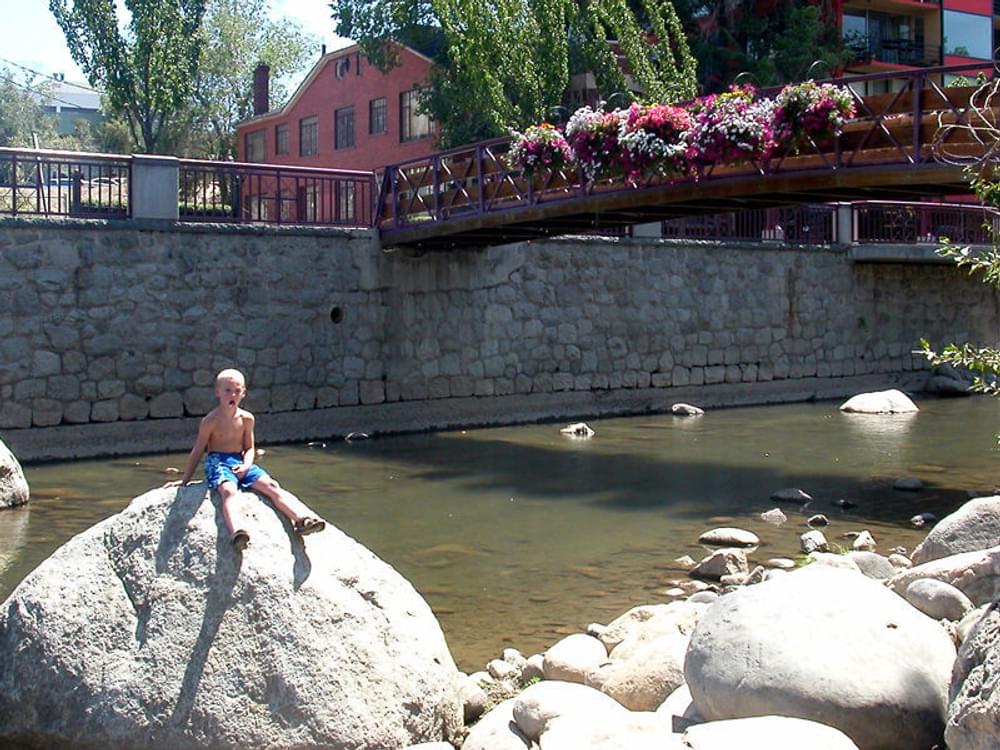 Trail provides access to the Truckee River in downtown Reno, Nevada. The pedestrian bridge extends from the island to the embankment on the south side of the river. 