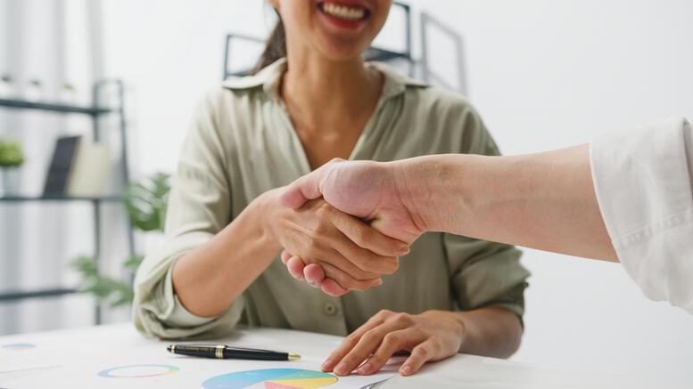 Multiracial group young creative people smart casual wear discussing business shaking hands together
