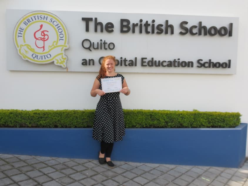Geography Teacher Natalie Sawyers proudly shows her certificate