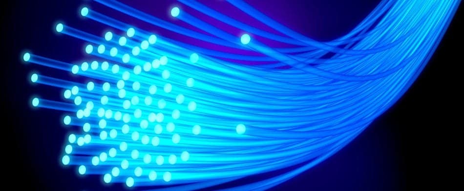 a bundle of glowing blue fiberoptic cables 