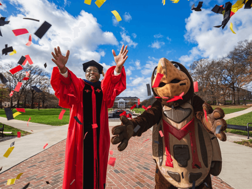 President Pines and Testudo celebrating graduation
