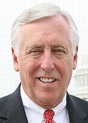 Full color photo of Steny Hoyer smiling wearing a suit with the Capitol building in the background.