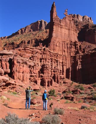 Hikers and leashed dog on the Fisher Towers trail. Photo by Valerie A. Russo.