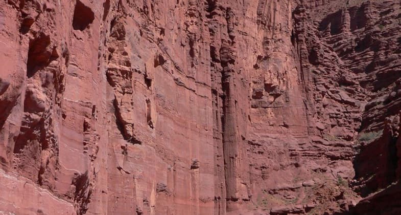 Red rocks wall with hiker for scale. Photo by Stuart Macdonald.