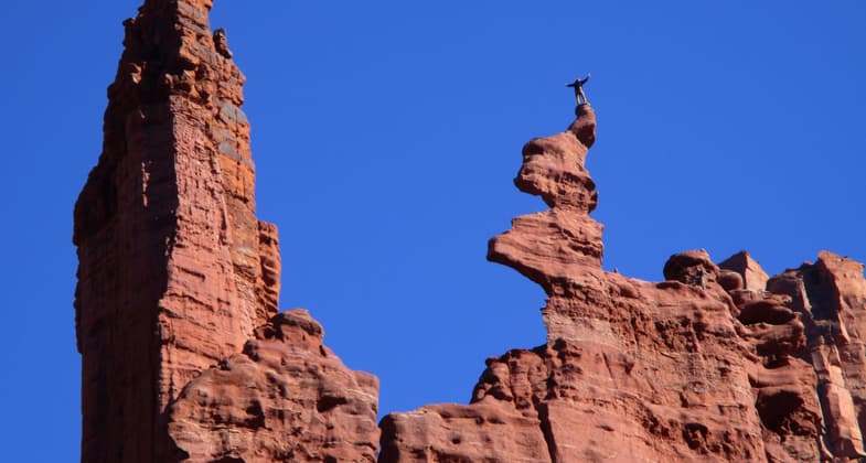 A climber savors the moment at Fisher Towers. Photo by Valerie A. Russo.