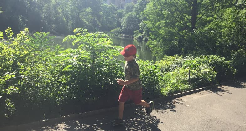 A boy runs along the trail in Central Park. Photo by Chris Sheffield.