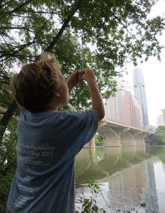 A young angler along the Ann and Roy Butler Hike and Bike Trail on Ladybird Lake in downtown Austin, Texas. Photo by Chris Sheffield.