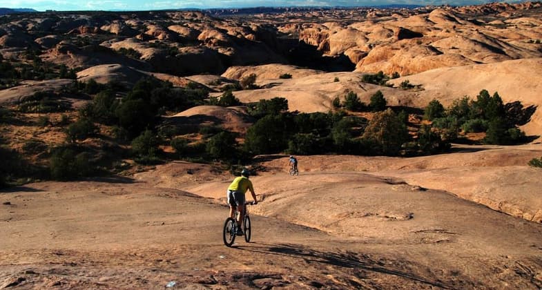 Mountain Bikers on slickrock bike trail in Moab, UT. Photo by Wikicommons.