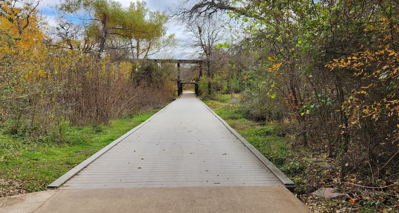 This board walk goes under a railroad track that carried Pink Granite to Austin during the building of the capital. Photo by Ciera Lanier.