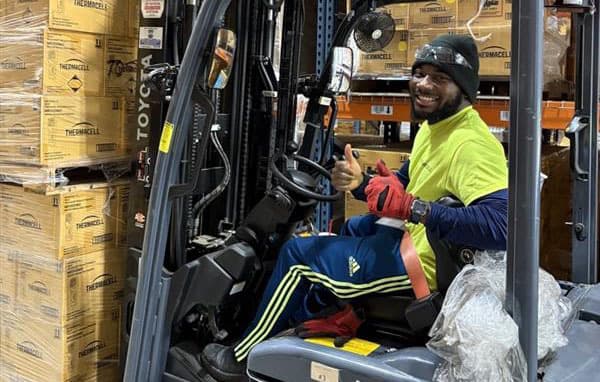 Thermacell employee with forklift full of donations