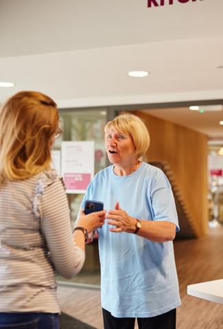 Octagon volunteer greeting customer