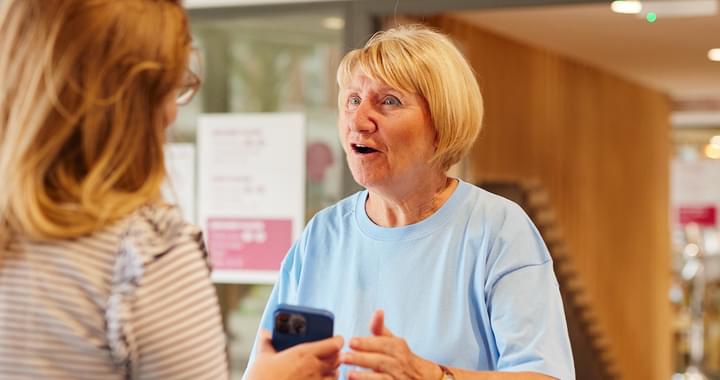 Octagon volunteer greeting customer