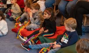 Children sitting on the floor listening to a story