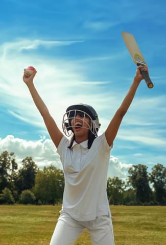 Woman holding a cricket ball and bat