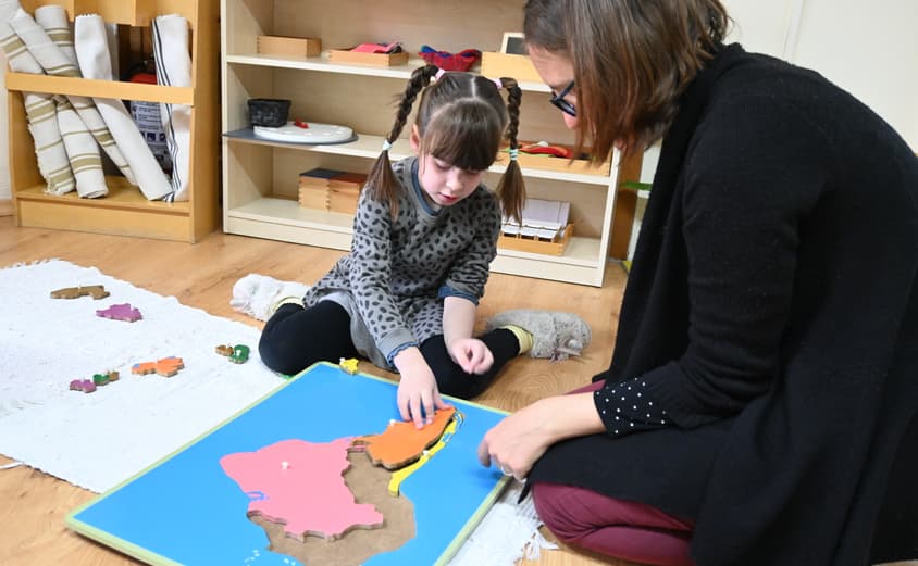 Child and teacher in Montessori nursery