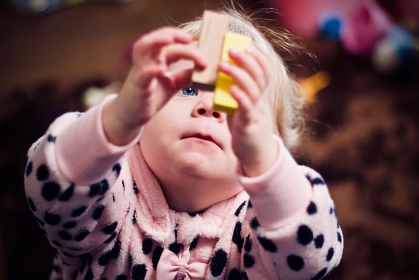 Child holding two wooden blocks