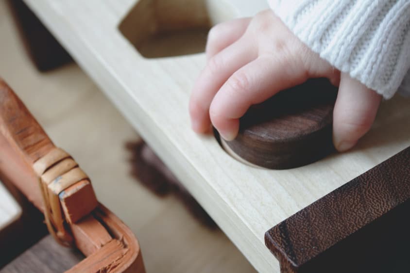 Hand on wooden block