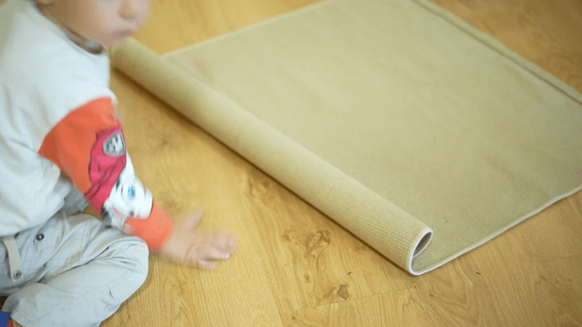 Montessori Student using a work rug