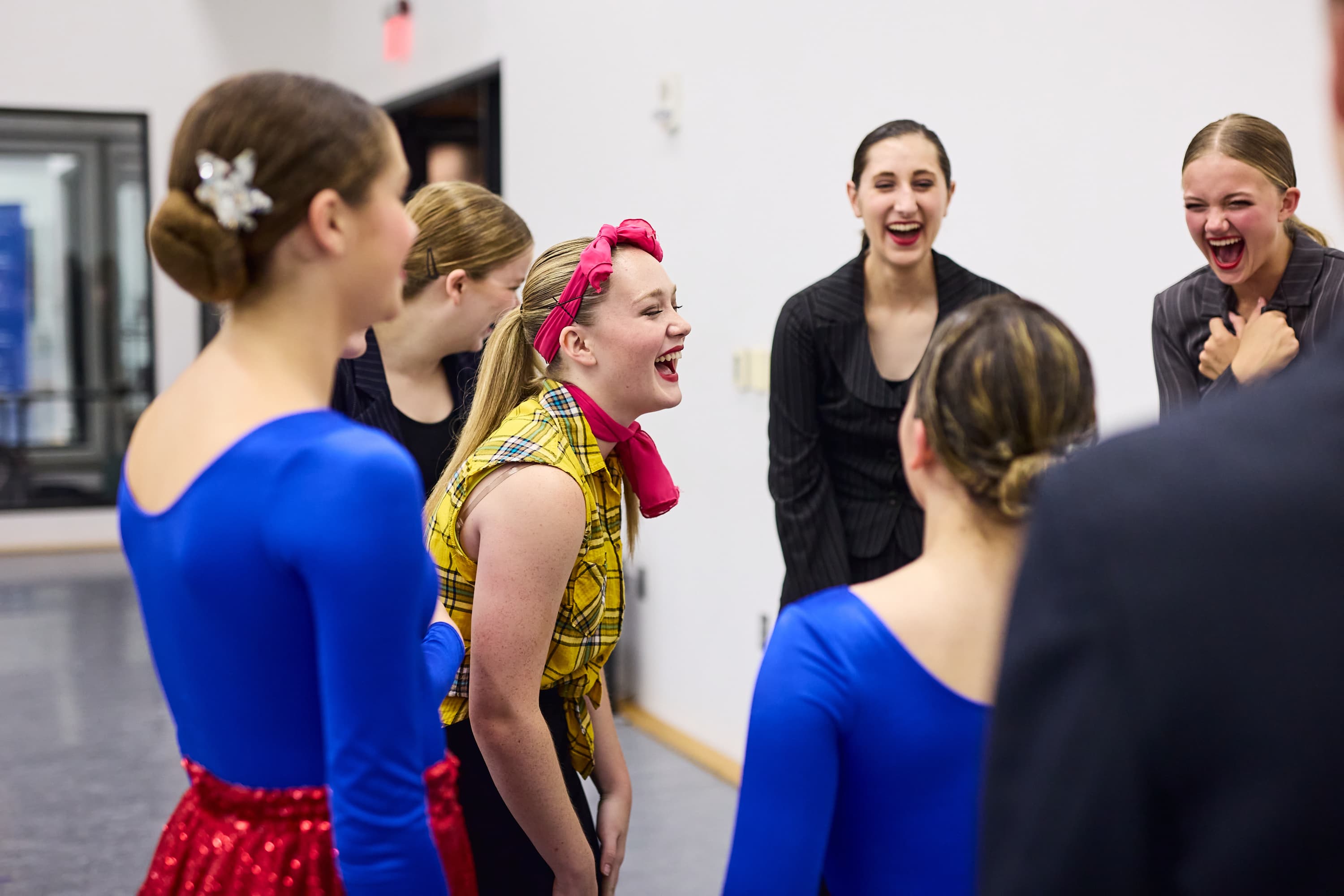 Students laughing with other students at rehearsal