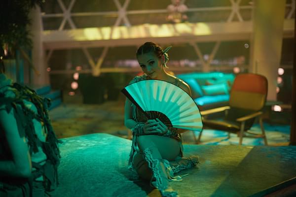 Alumna Halston Strange in costume for her job as a Celebrity Cruises performer and holding a fan. Alumna Halston Strange in costume for her job as a Celebrity Cruises performer and holding a fan.