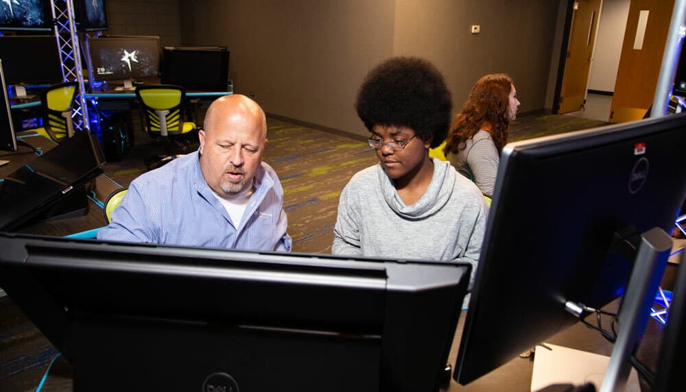 Jeff Price, director of OCU's game design and animation program, teaches a student one-on-one.