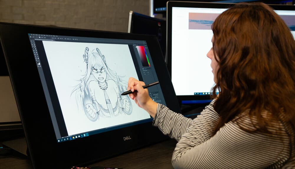 A student draws on a digital tablet in OCU's game design and animation lab.