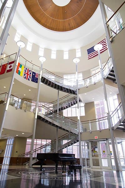The Meinders School of Business lobby, a three-story atrium with flags of the world displayed.