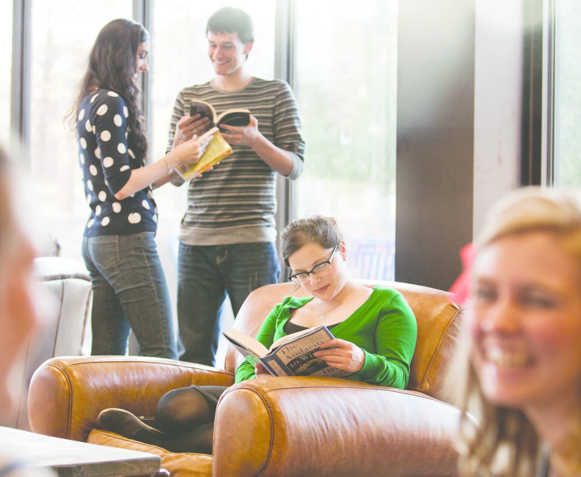 students read and talk in the library lounge
