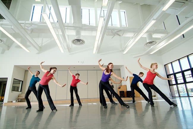 Dancers practice in a bright room in the Lacy School