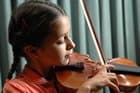 A young girl plays a violin A young girl plays a violin