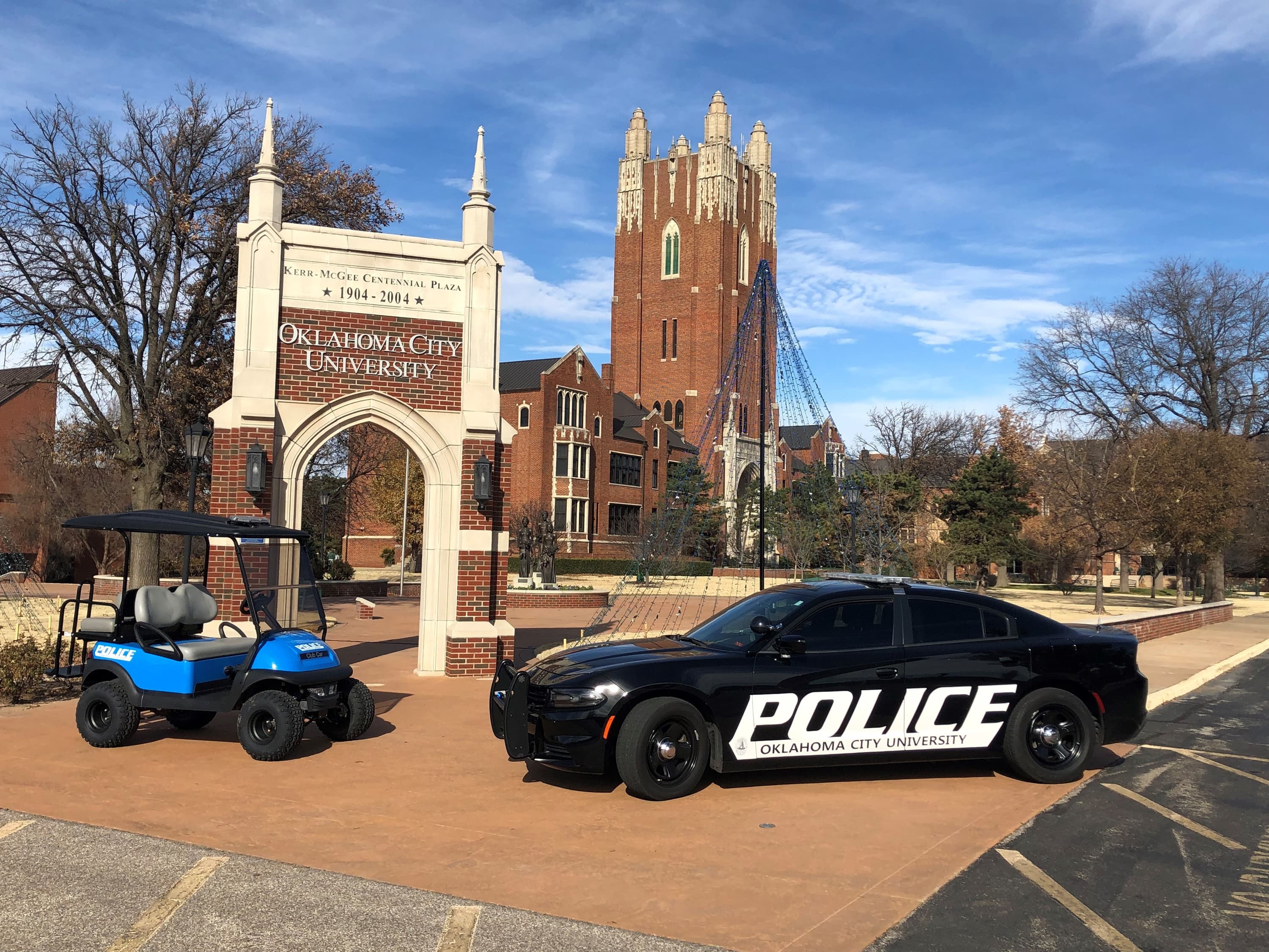 O C U P D vehicles are parked by the campus's entryway