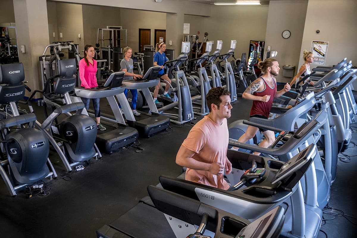 OCU Fitness Center - five students running on treadmills