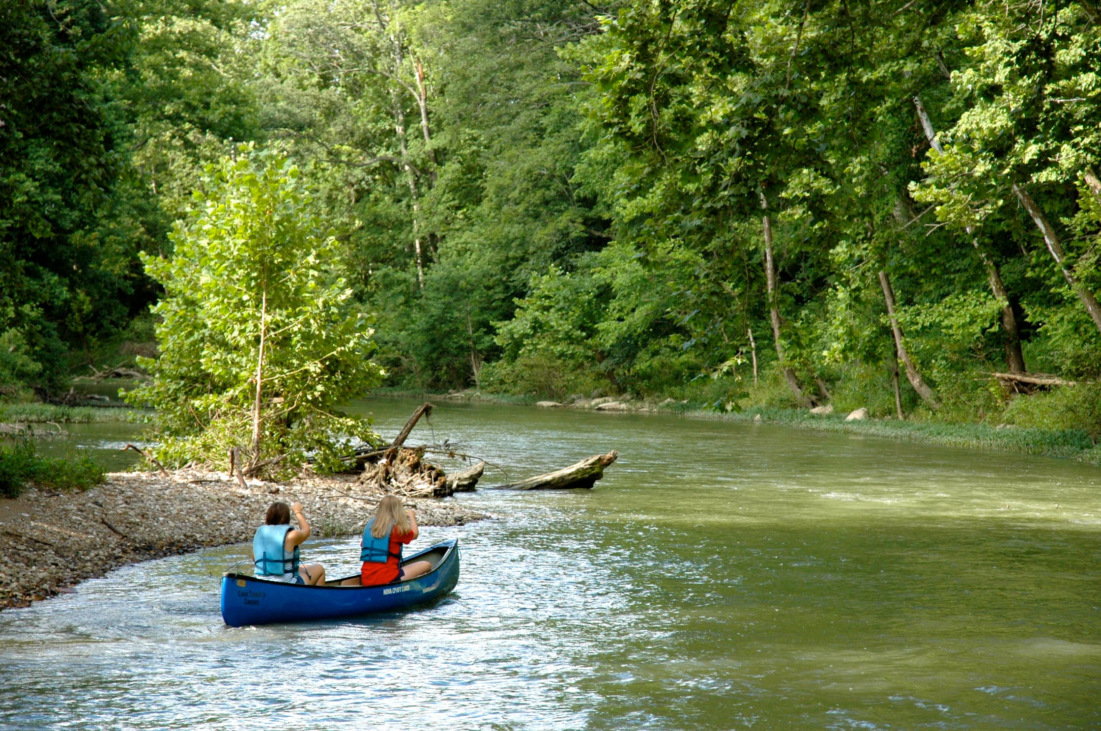 Two canoers enjoy their trip down the beautiful Blue River