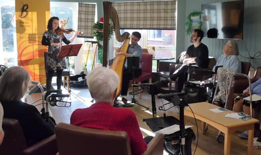 Group of musicians playing in a care setting