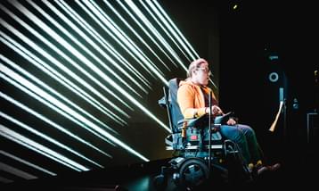 A young musician in a wheelchair performing using a wheelchair controller.