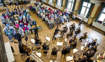 A view from above of an orchestra and care home audience.