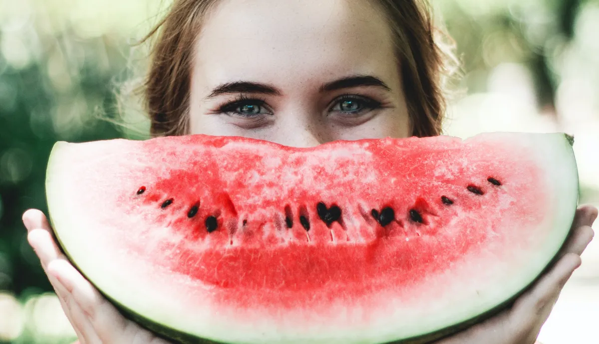 Woman smiling with a watermelon