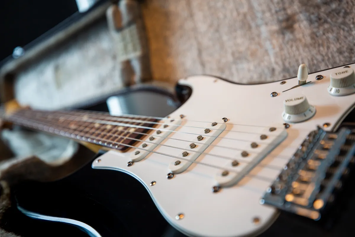 Selective focus photography of black electric guitar 1589280