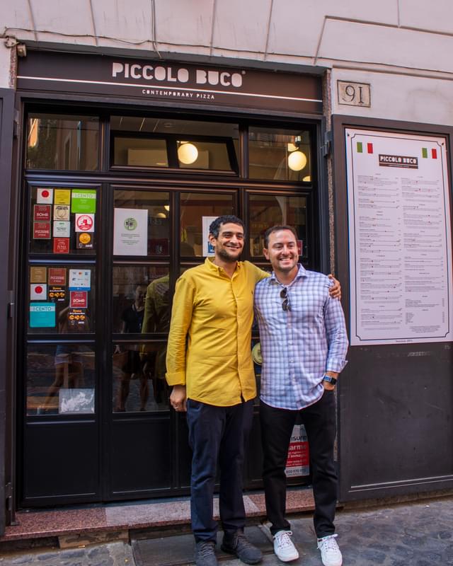 Two men standing in front of a building.