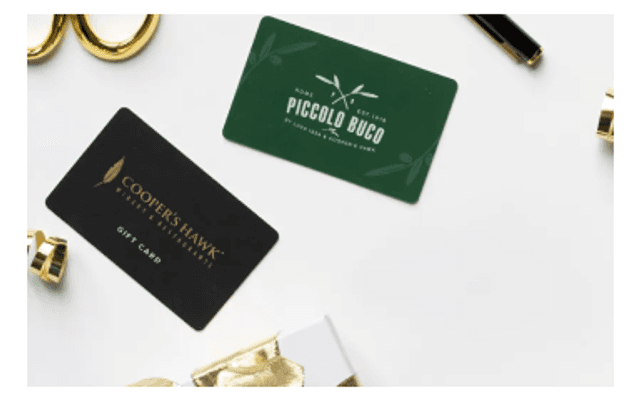 Cooper's Hawk and Piccolo Buco gift cards on a white table